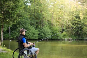 MND person fishing from a wheelchair